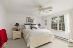 Second bedroom on the upper level with a queen bed and ceiling fan